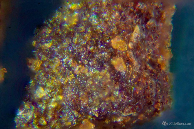 Microscopic photo of roasted ground coffee beans for making filter coffee.